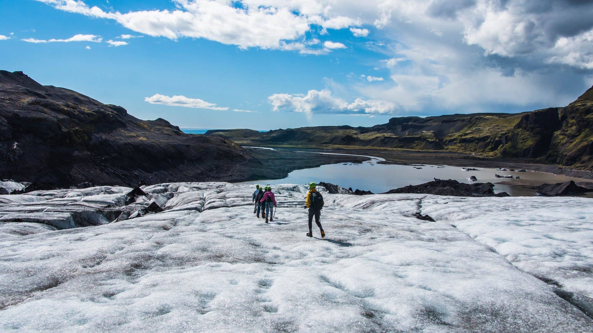 Hikers explore the crevassed surface of Sólheimajökull glacier on the south coast of Iceland.