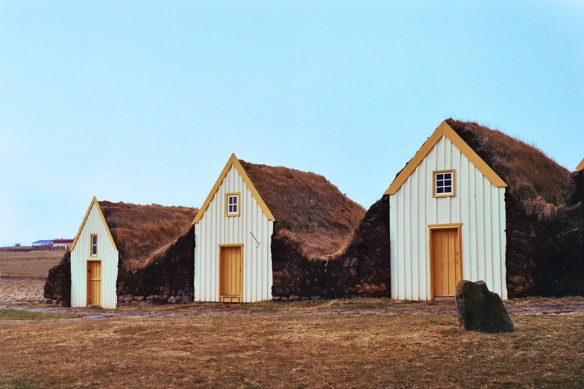 The turf houses of the Glaumbær farm museum stand under a blue summer sky in North Iceland.