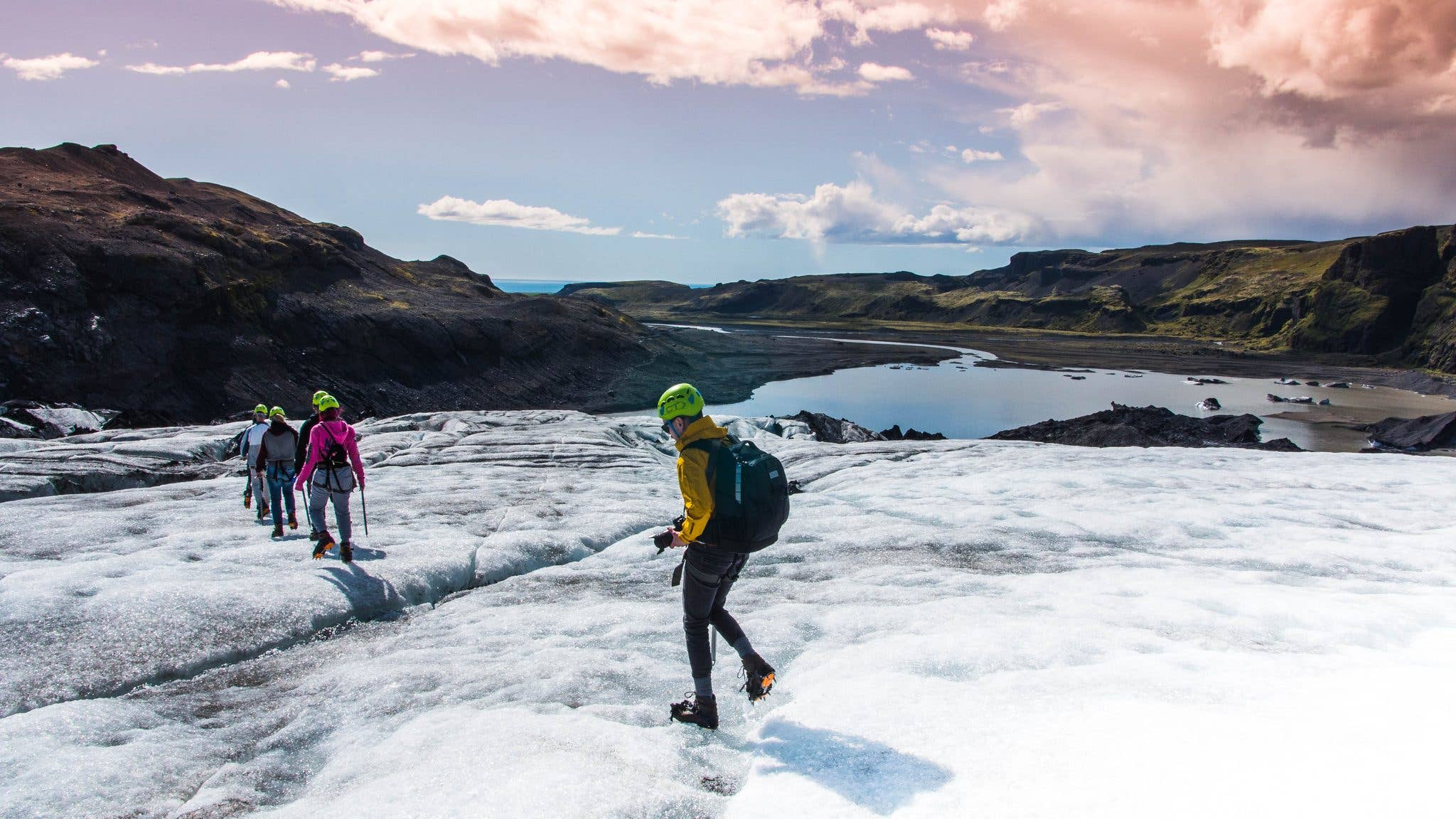 A group of hikers crosses the ice of a glacier tongue in southern Iceland.