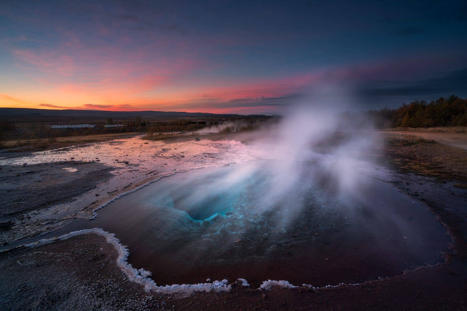 Steam drifts across the Geysir geothermal field on the Golden Circle in southwest Iceland.