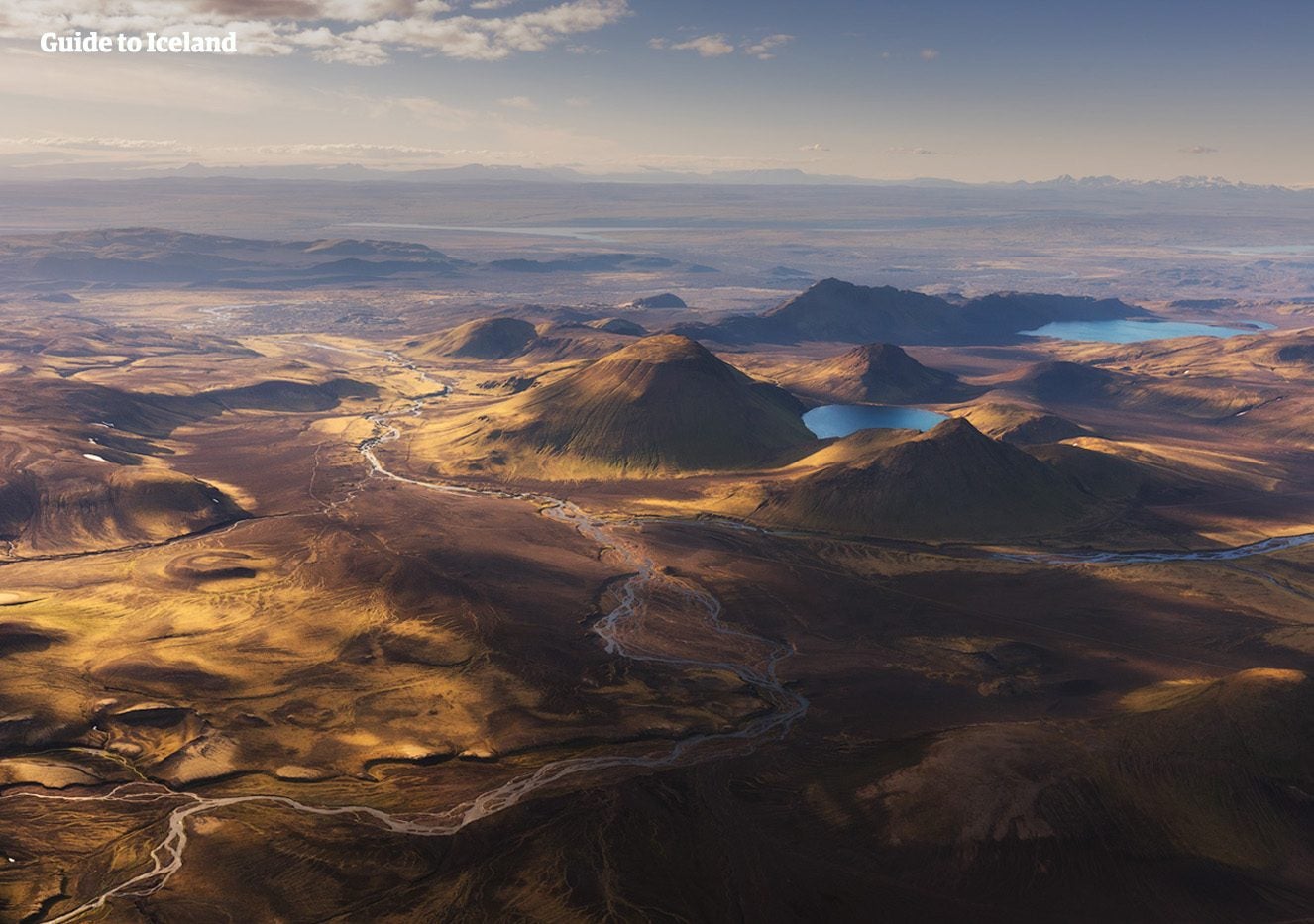 Volcanic craters and small lakes dot a vast Highland plain in the interior of Iceland.