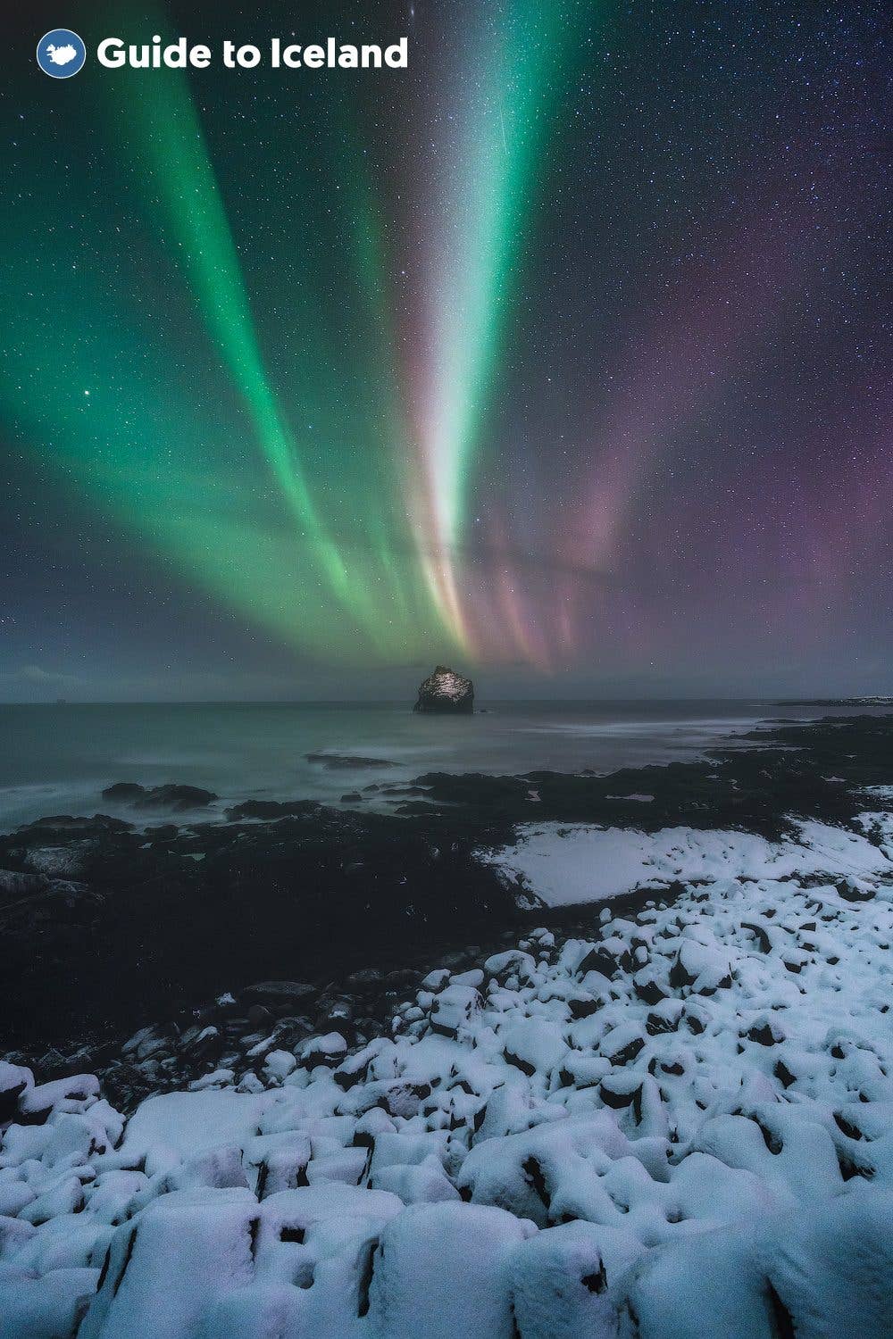 The northern lights fill the sky over a snow-covered lava field on the Reykjanes Peninsula, Iceland.