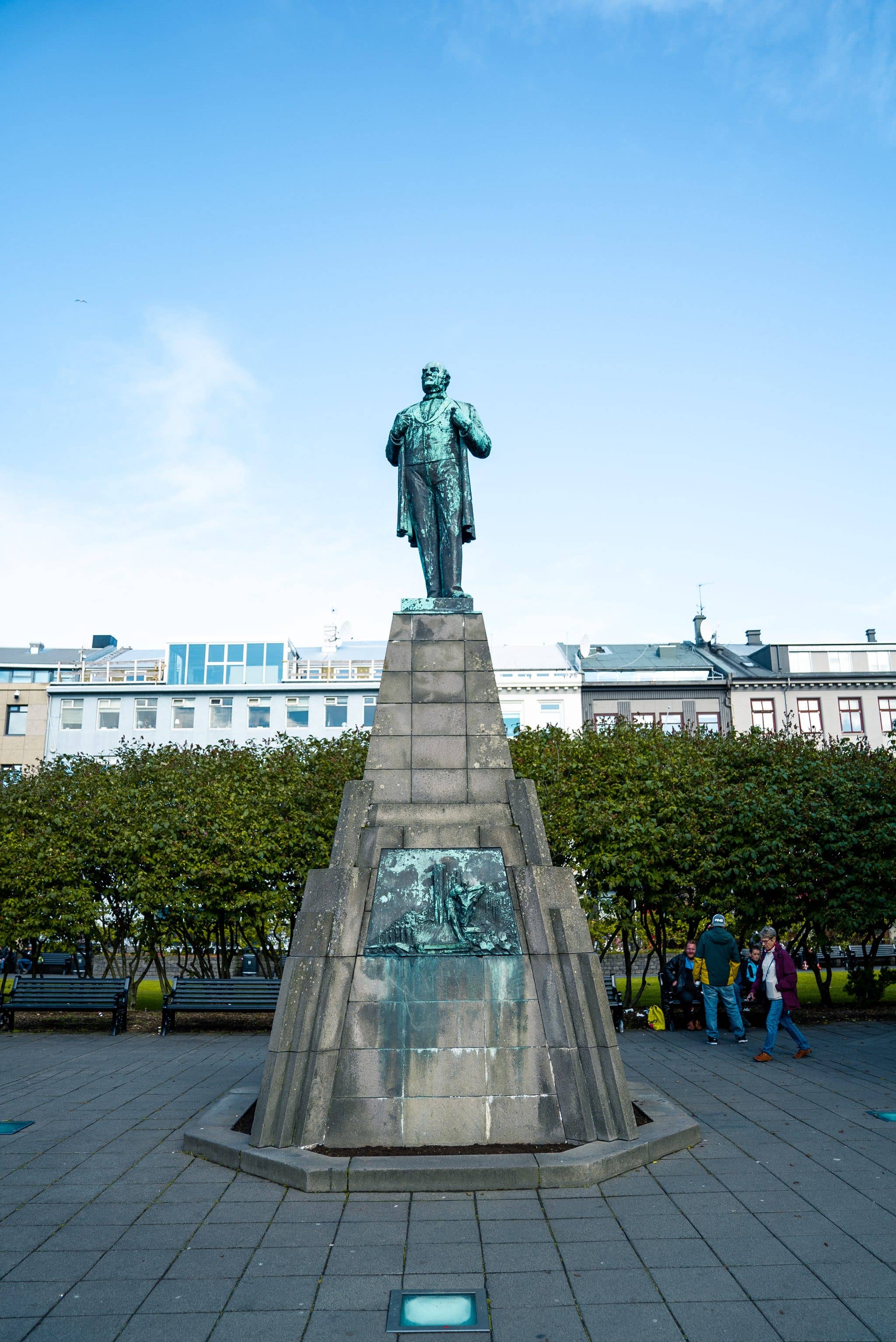 The statue of Jón Sigurðsson rises above the green Austurvöllur square in central Reykjavík, Iceland.