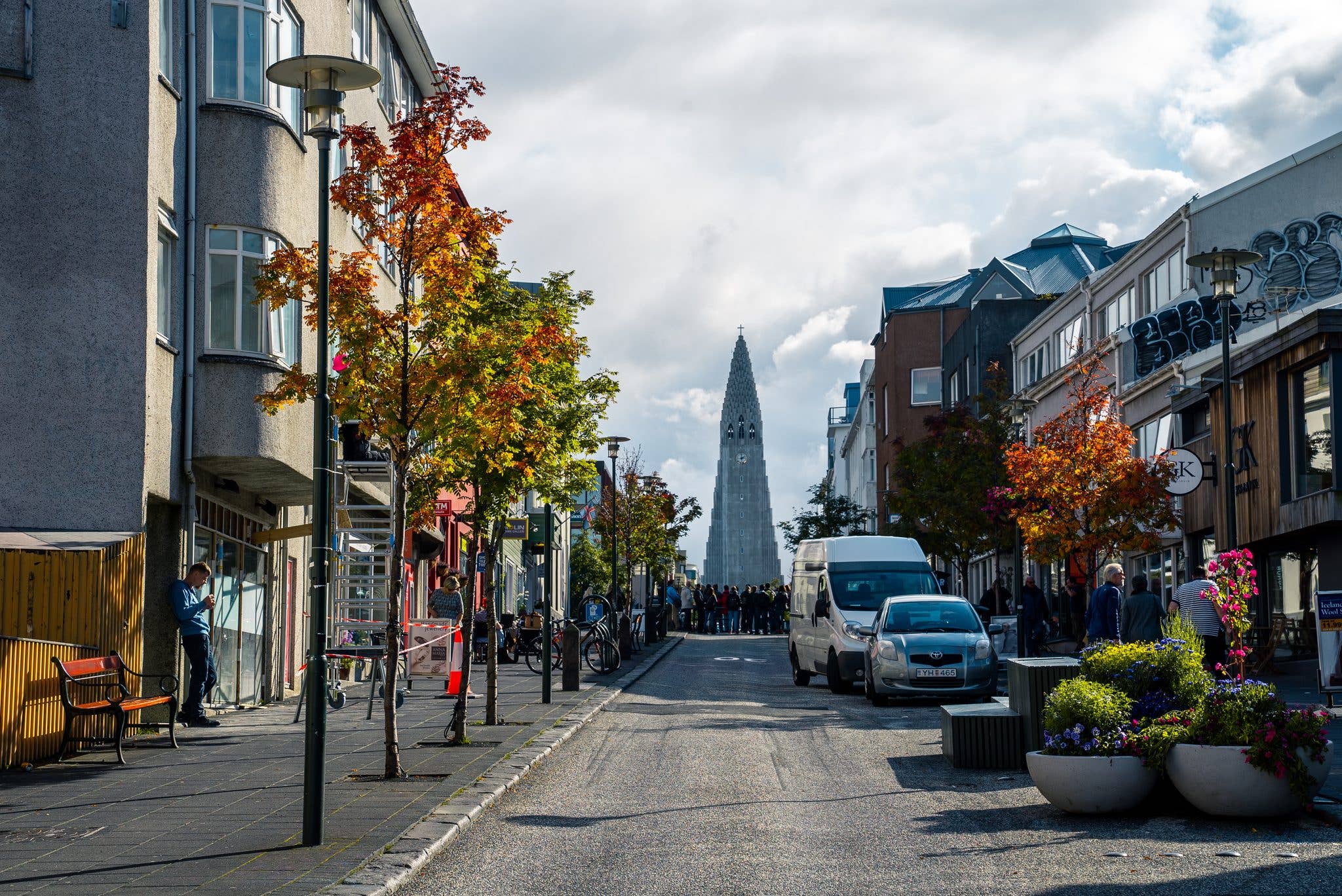 An autumn street leads toward the Hallgrímskirkja church in central Reykjavík, Iceland.
