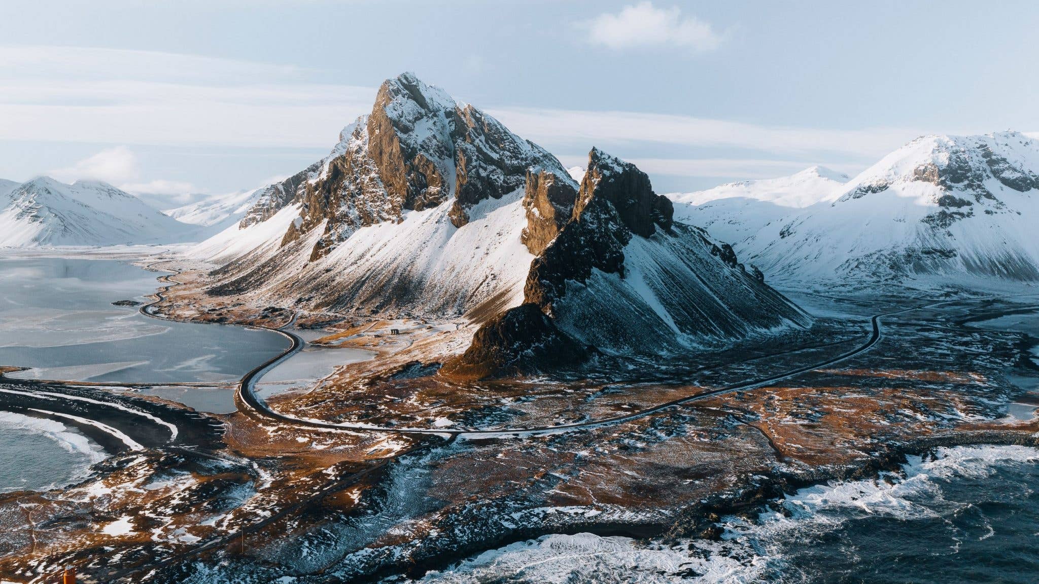 Snow covers the jagged Eystrahorn mountain above the coast in East Iceland.