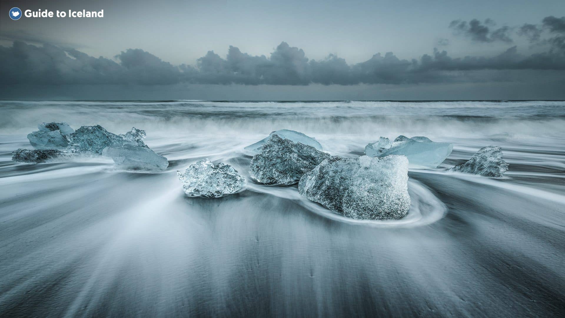 Icebergs rest on the black sand of the Diamond Beach in winter in Southeast Iceland.