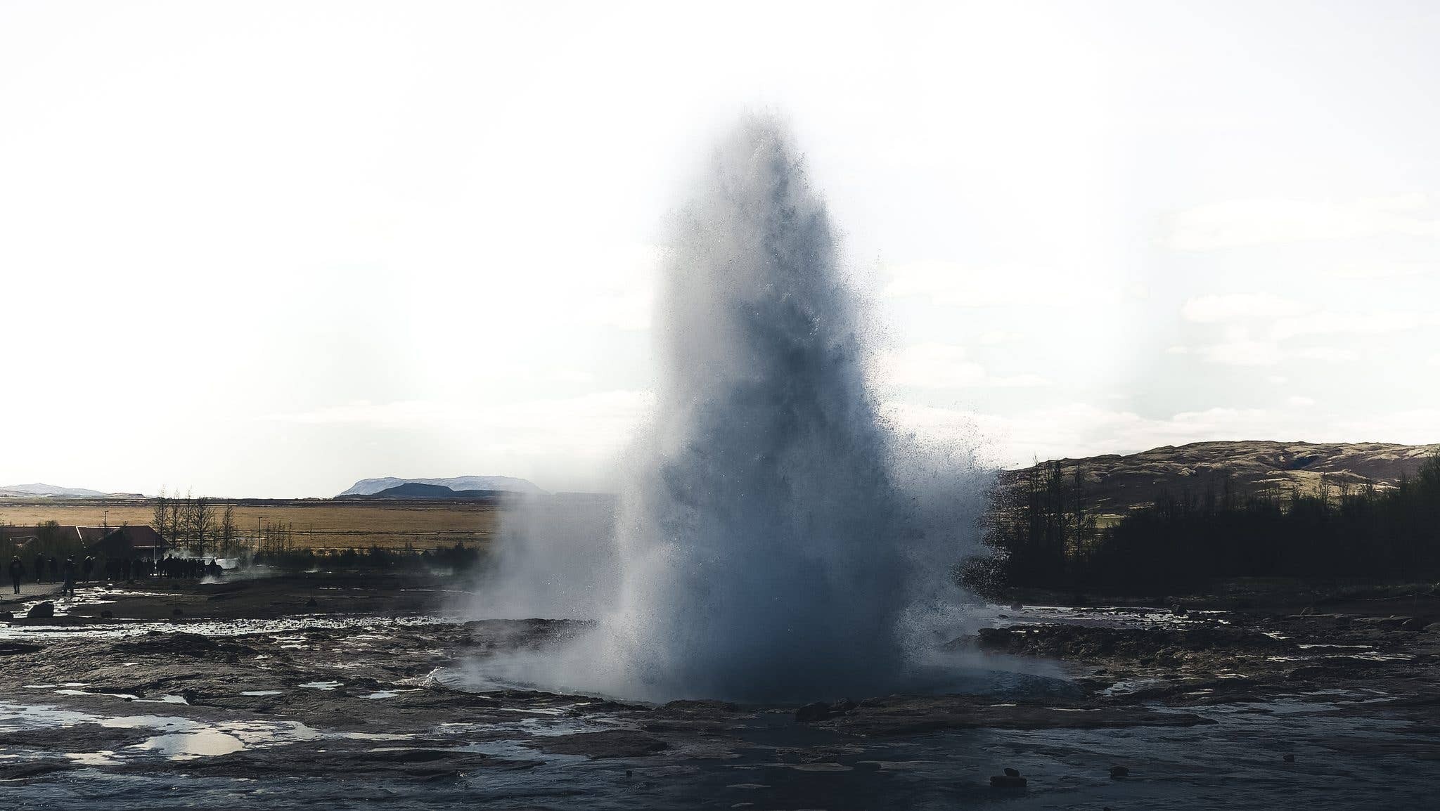 The Strokkur geyser bursts skyward in the Geysir geothermal area on the Golden Circle in Iceland.