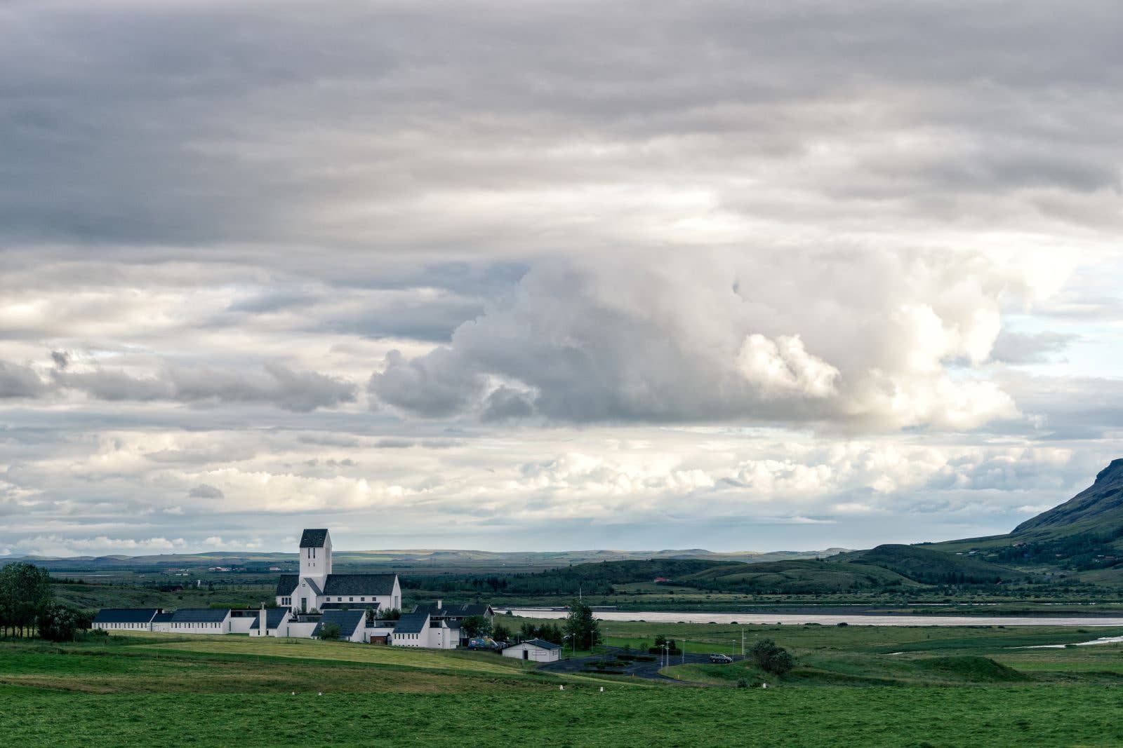 The historic Skálholt cathedral stands on the green plains of South Iceland.