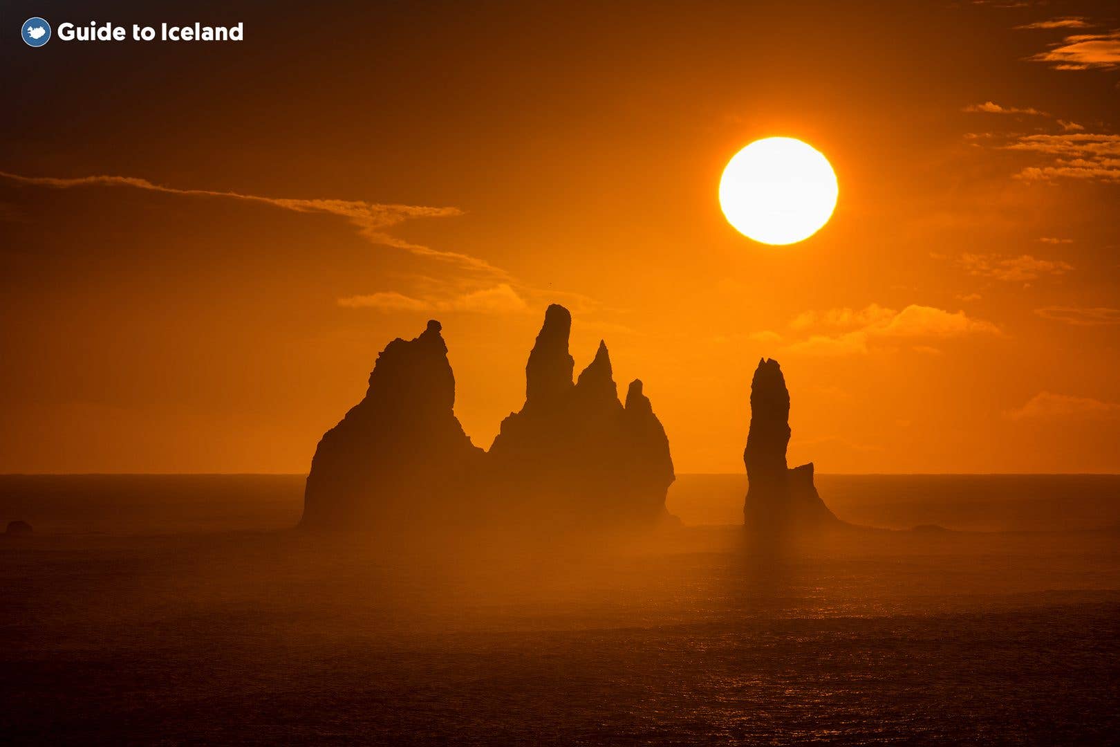 The Reynisdrangar sea stacks rise from the ocean off the black beach near Vík in South Iceland.