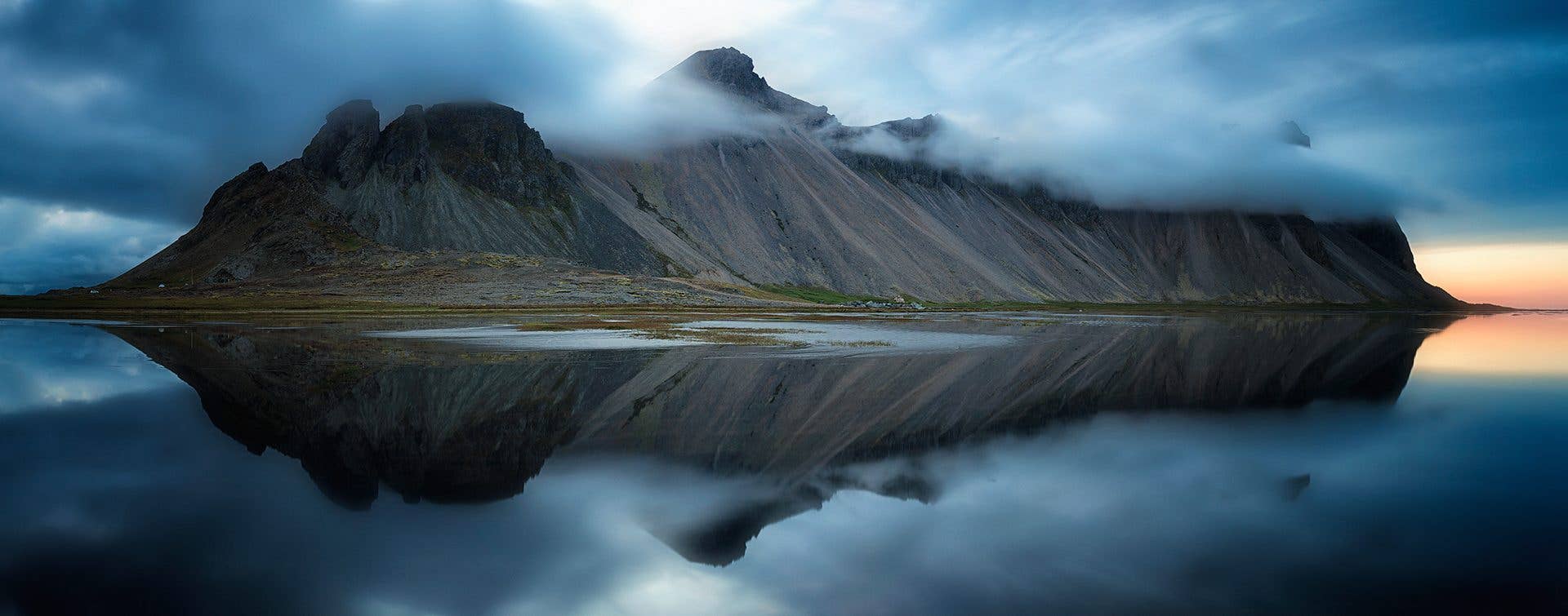 Vestrahorn mountain mirrors in the still water at Stokksnes in Southeast Iceland.