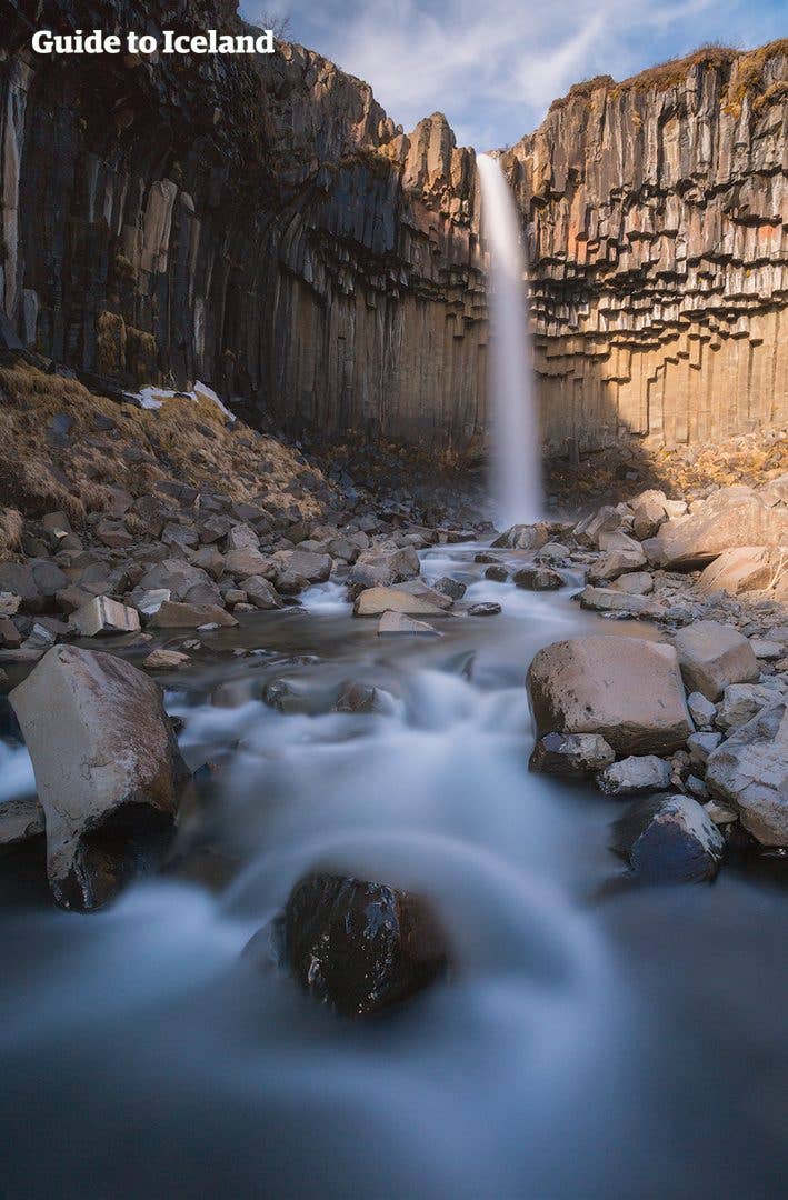 The Svartifoss waterfall falls over dark basalt columns in Skaftafell, South Iceland.