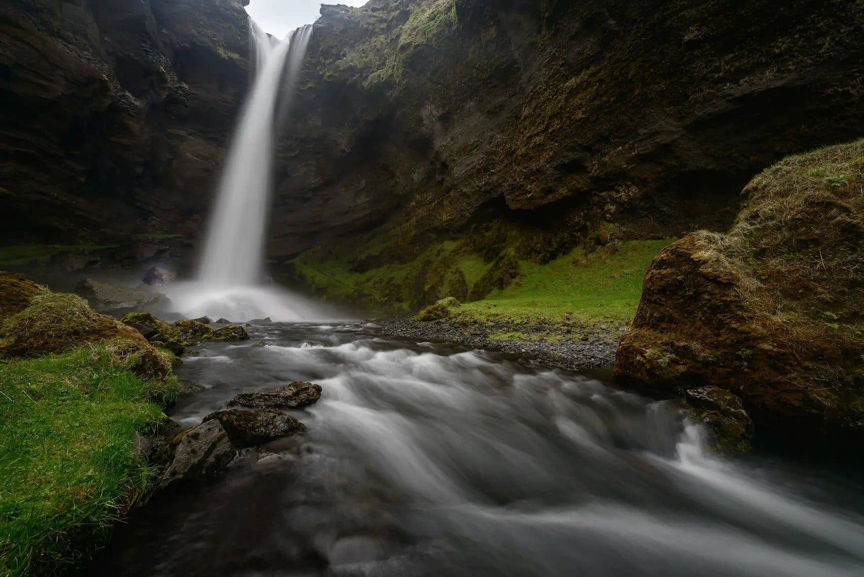 The Kvernufoss waterfall drops into a green gorge near Skógar in South Iceland.