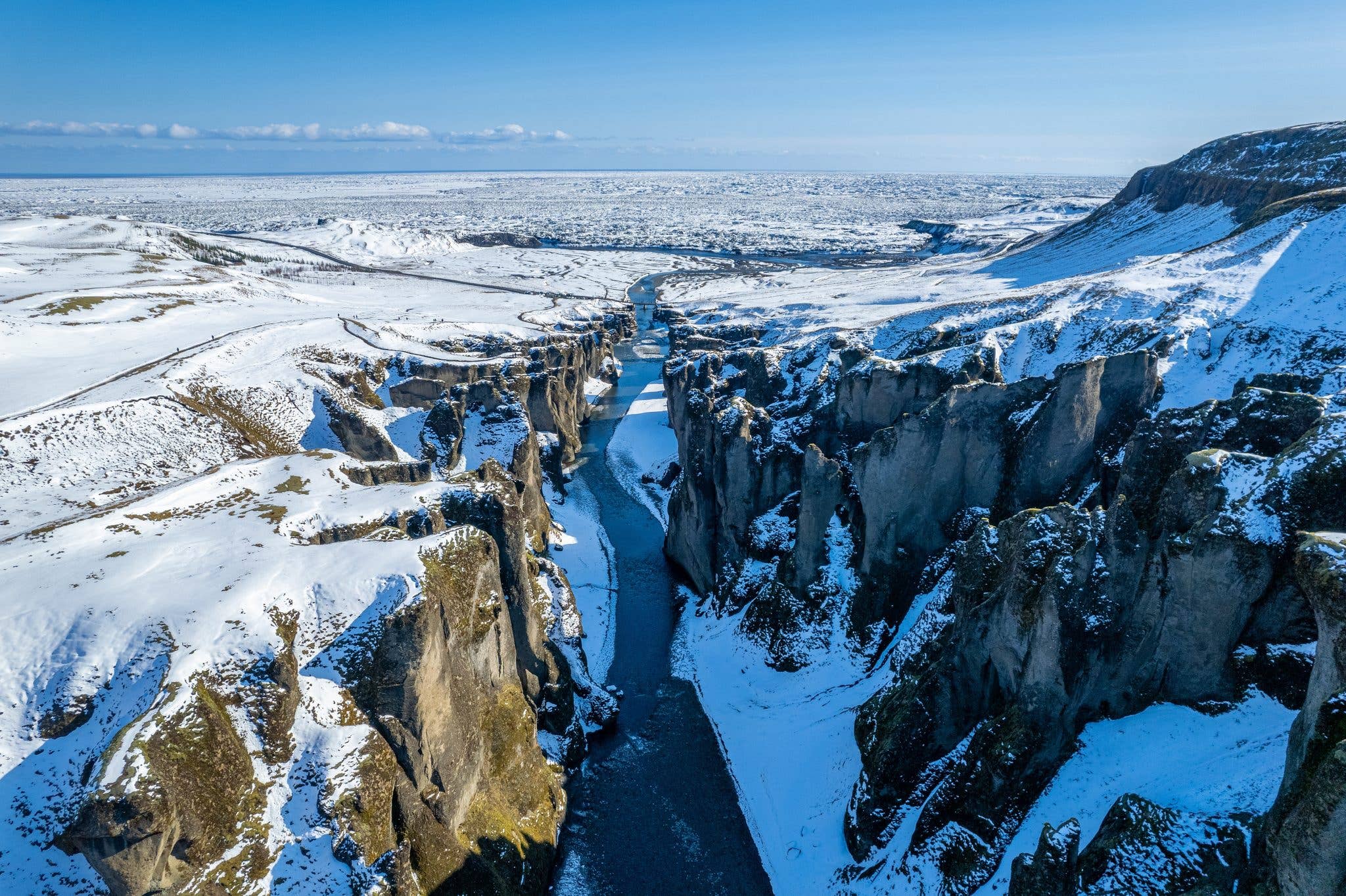 The winding Fjaðrárgljúfur canyon cuts through the moss-covered landscape of South Iceland.