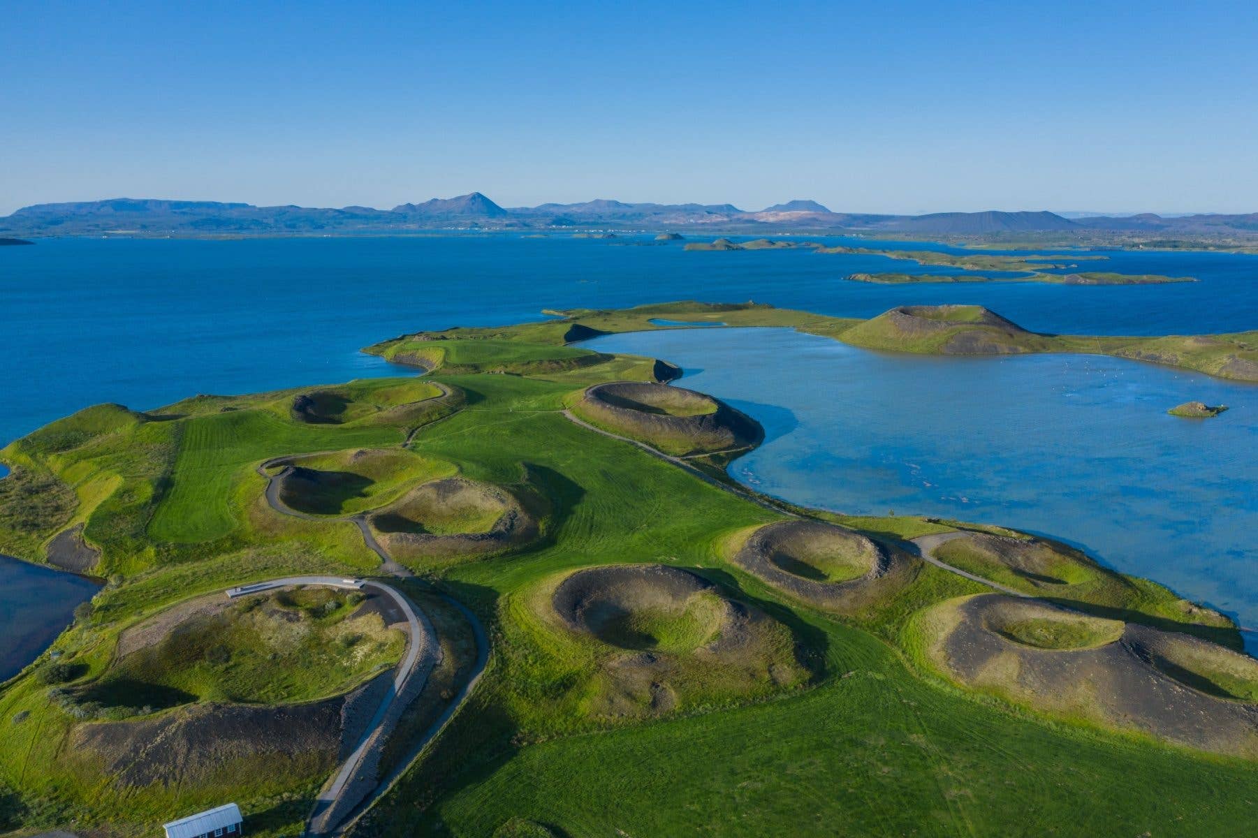 Green pseudo-craters dot the shore of Lake Mývatn in North Iceland.