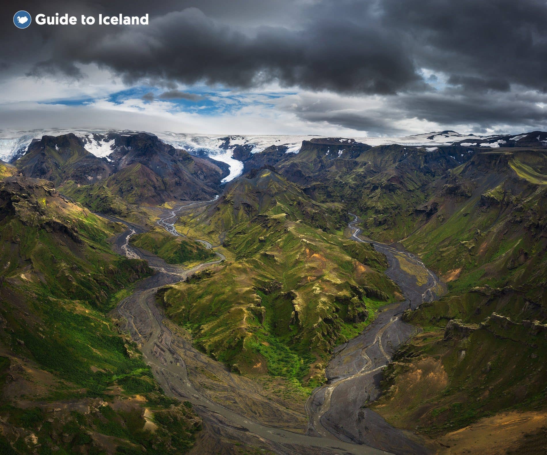 Green ridges and glacial rivers fill the Þórsmörk valley in the Icelandic highlands.