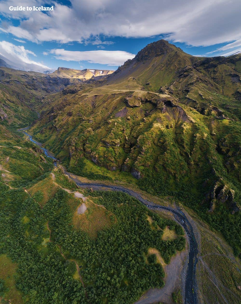 Mossy hills and birch woods cover the Þórsmörk nature reserve in the highlands of Iceland.