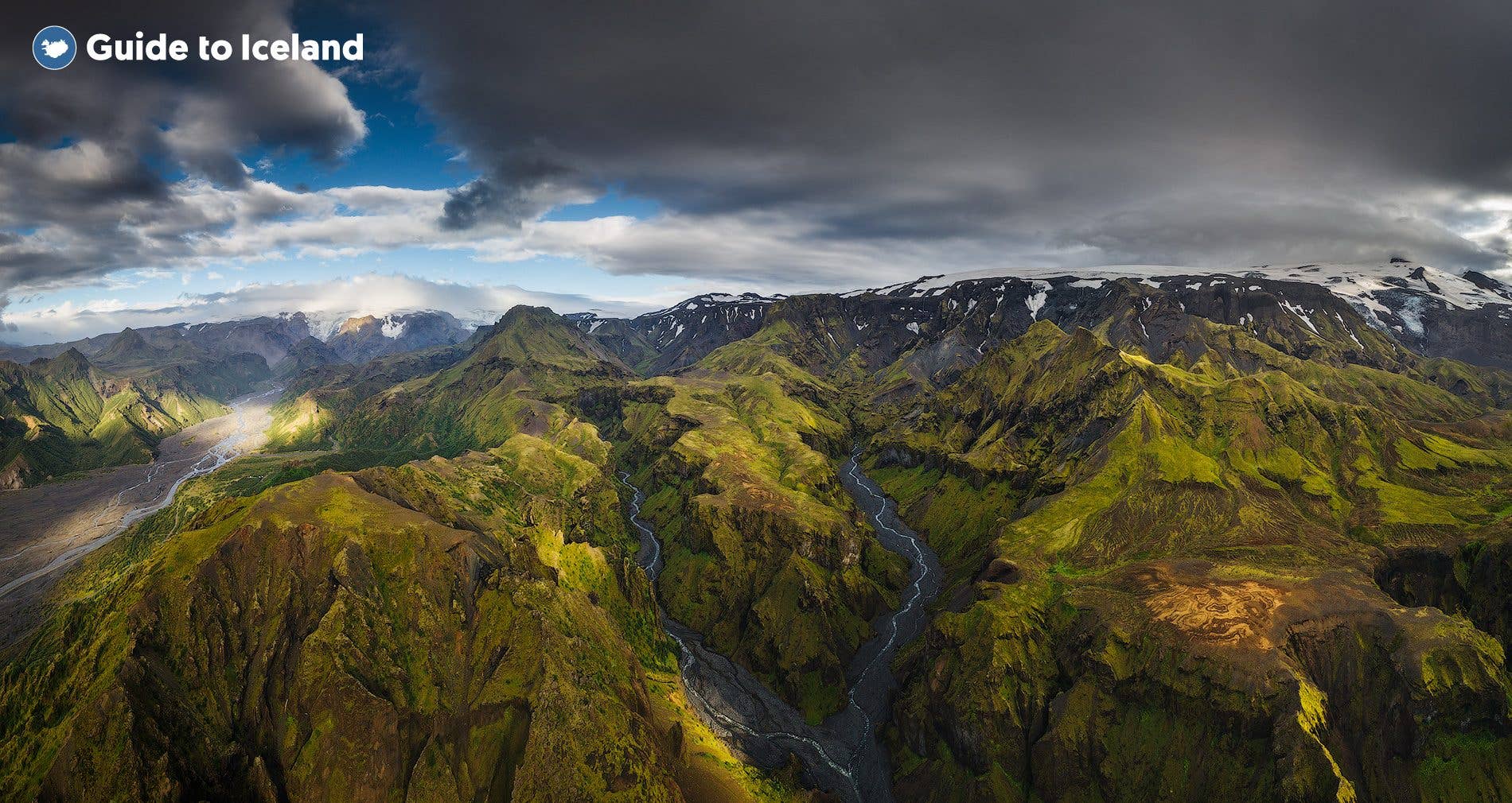 Green mossy ridges fill the Þórsmörk valley between glaciers in the highlands of Iceland.
