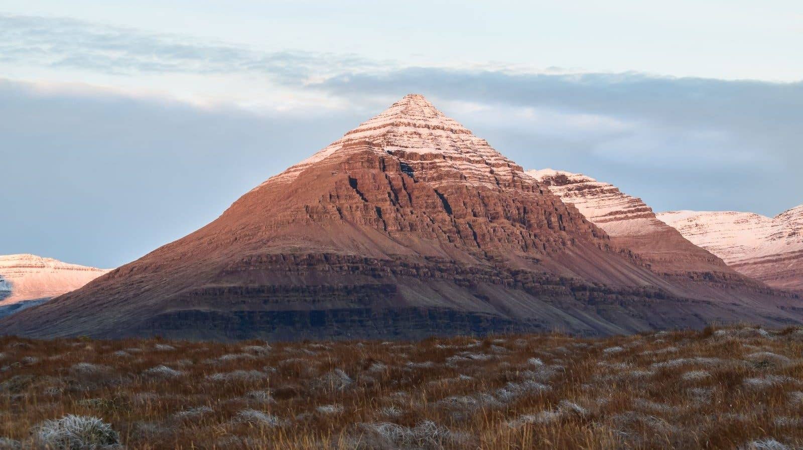 The pyramid-shaped Búlandstindur mountain rises above the coast near Djúpivogur in East Iceland.