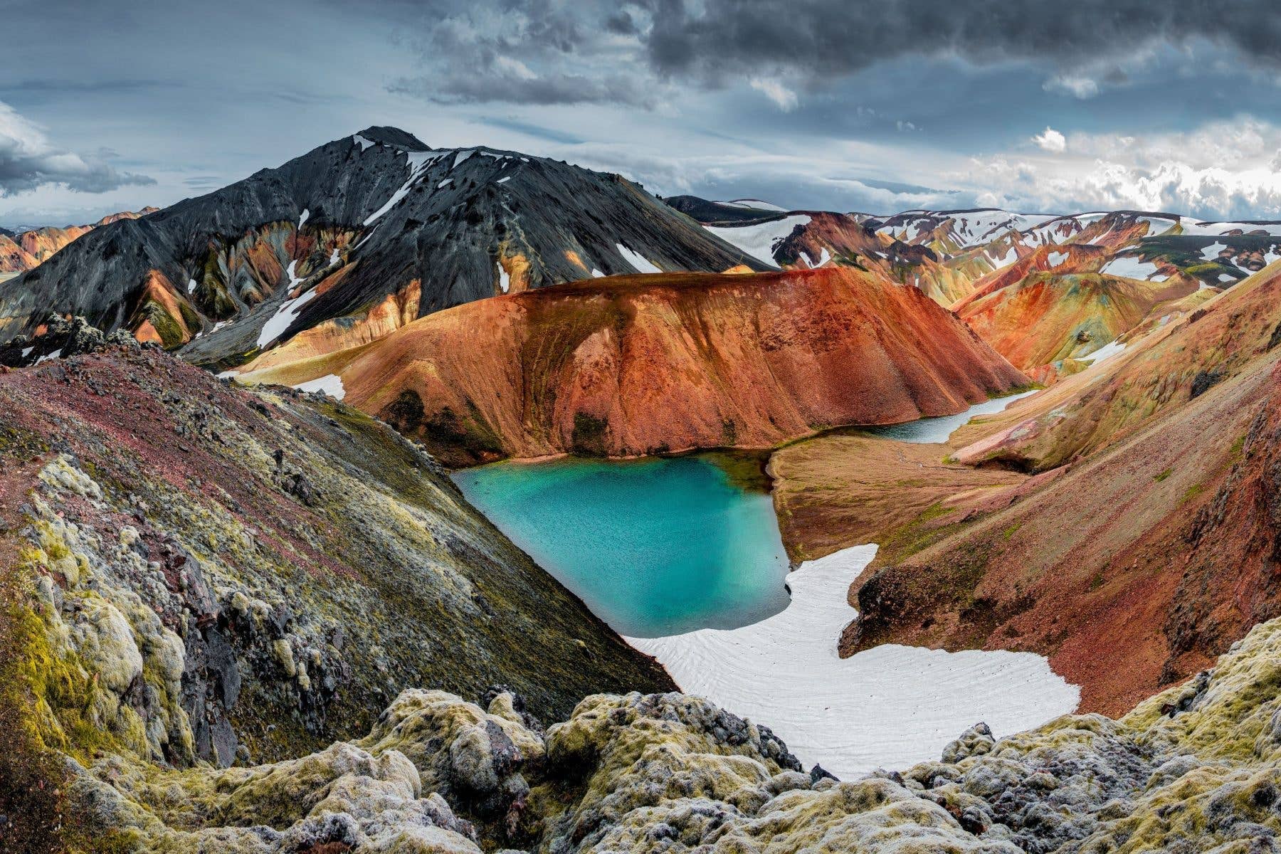 The colourful rhyolite mountains of Landmannalaugar glow along the Laugavegur trail in the Icelandic highlands.