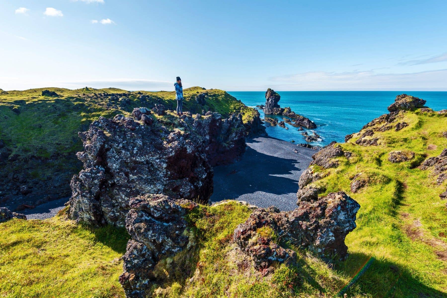 Lava rock formations line the Djúpalónssandur black beach on the Snæfellsnes Peninsula, Iceland.