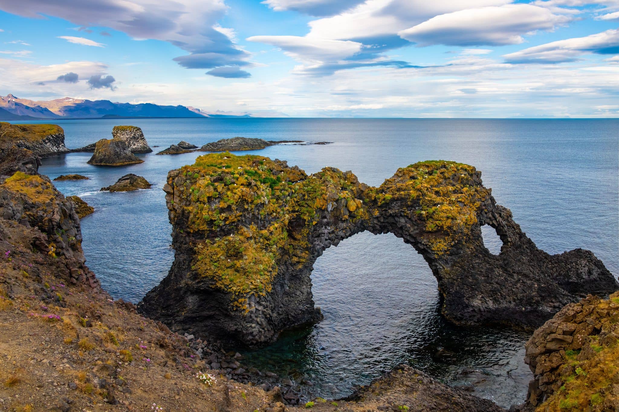 The Gatklettur sea arch frames the ocean near Arnarstapi on the Snæfellsnes Peninsula, Iceland.