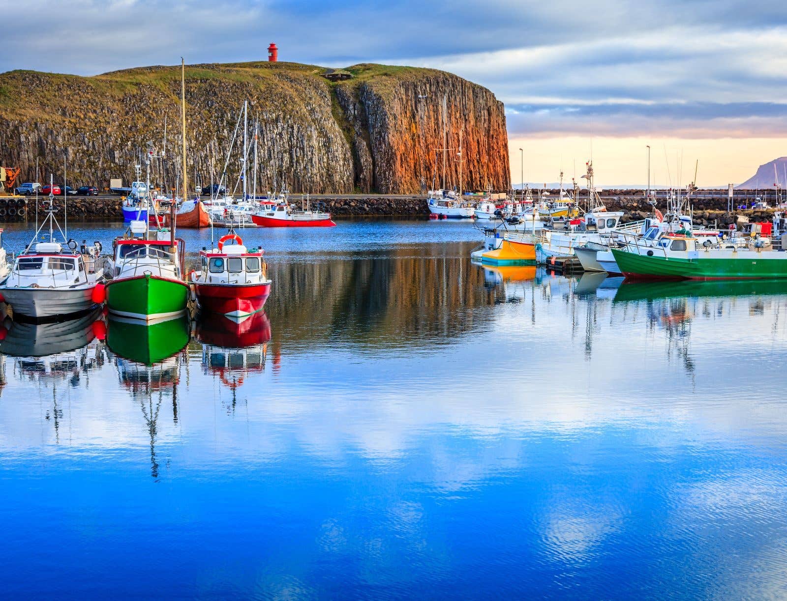 Colourful fishing boats fill the harbour of Stykkishólmur on the Snæfellsnes Peninsula, Iceland.