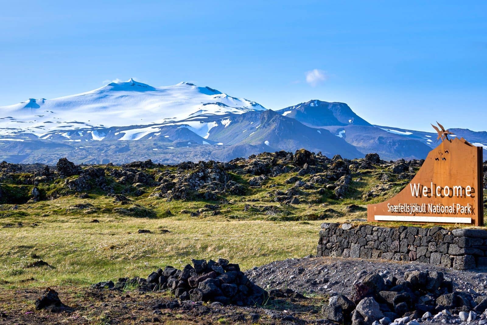 The Snæfellsjökull glacier rises over the lava fields of its national park on the Snæfellsnes Peninsula, Iceland.