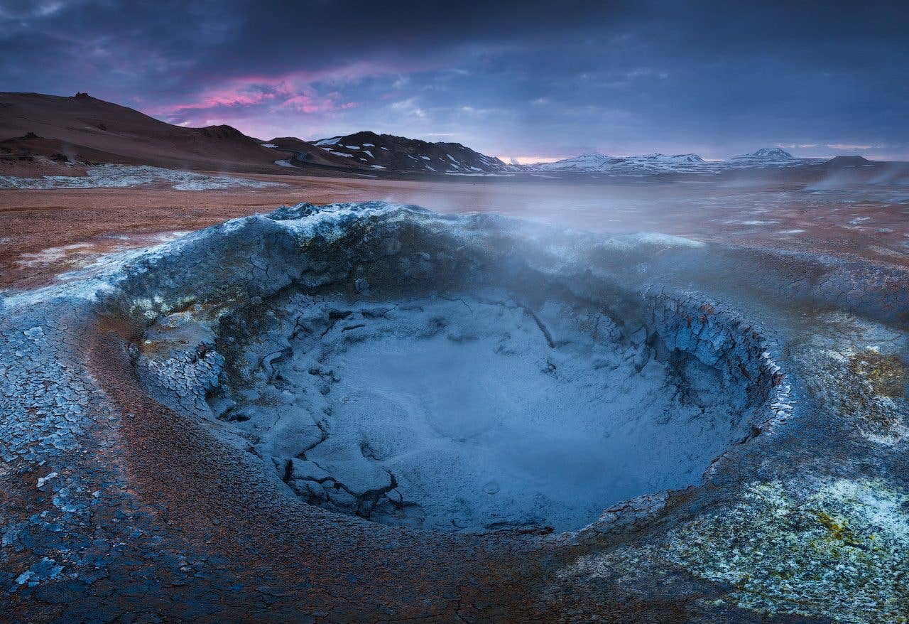 A bubbling mud pot steams in the Hverir geothermal area near Lake Mývatn in North Iceland.