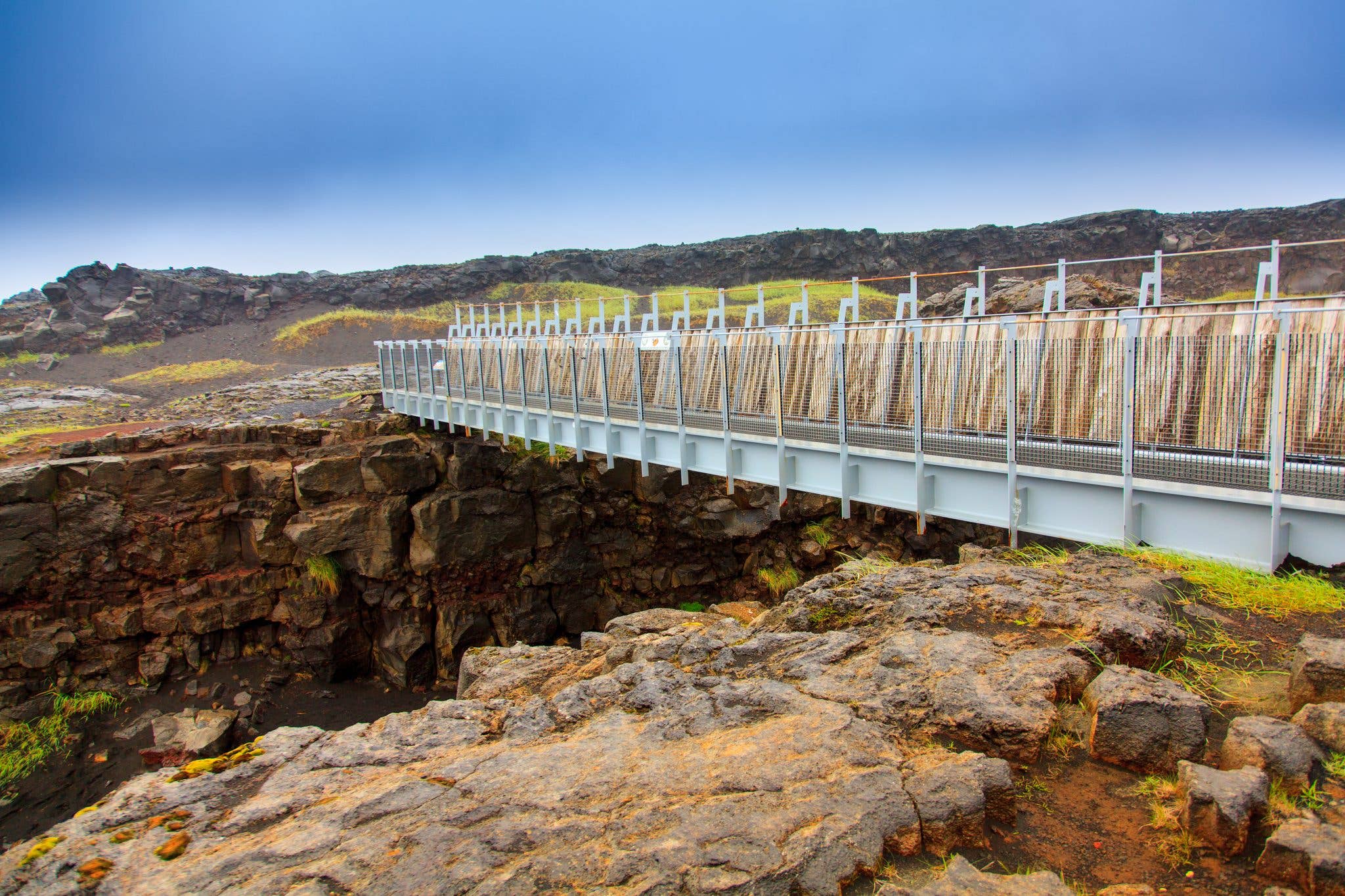 The Bridge Between Continents spans the rift between tectonic plates on the Reykjanes Peninsula in summer, Iceland.