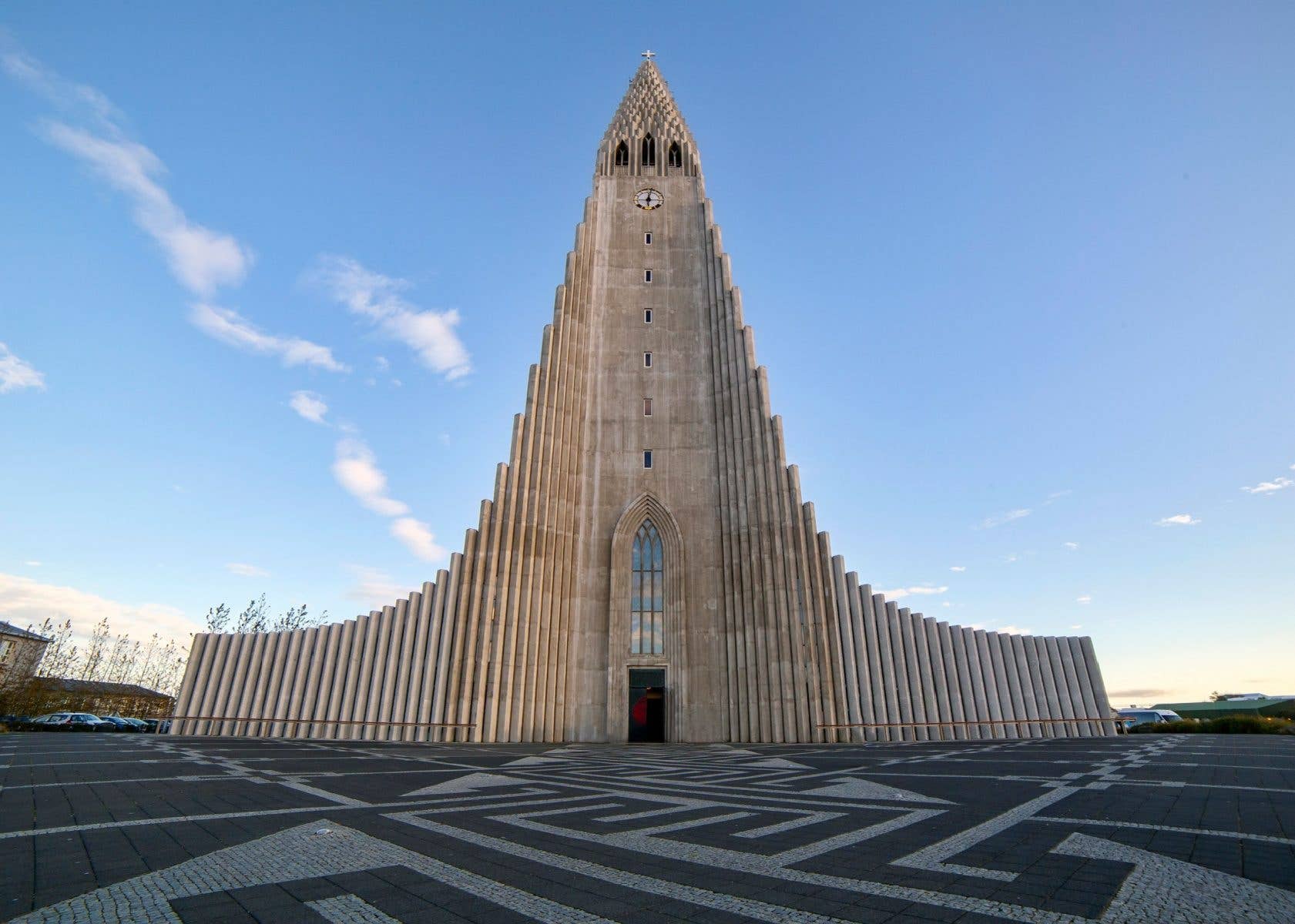 The Hallgrímskirkja church rises under a bright blue summer sky in Reykjavík, Iceland.