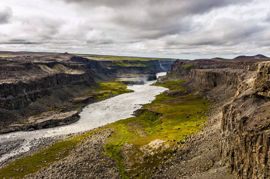 Steep cliffs and green vegetation lining Jokulsargljufur Canyon in North Iceland.