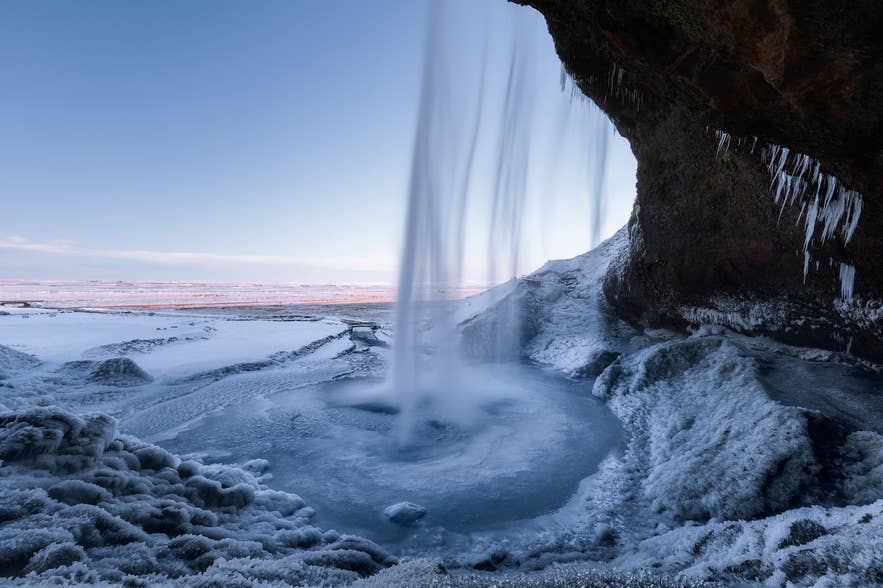 Seljalandsfoss waterfall falling over a mossy cliff in South Iceland