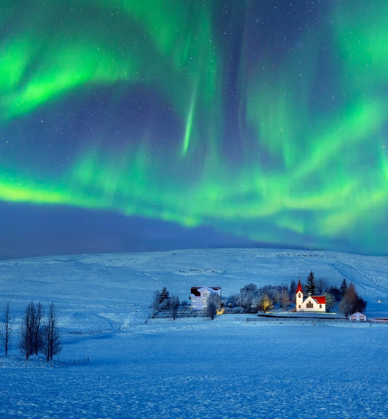 Aurora borealis glowing over Hvolsvollur, South Iceland.