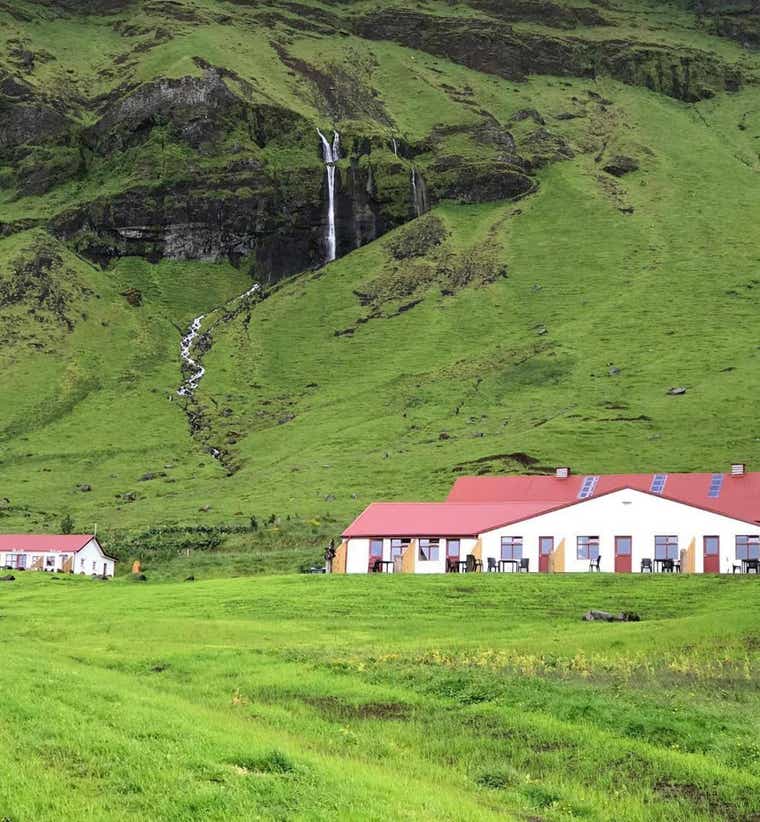 Hvolsvollur apartments surrounded by Icelandic countryside and mountain views.
