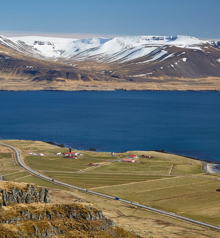 Aerial view of Akranes town with the coastline, harbor, and surrounding mountains in West Iceland.