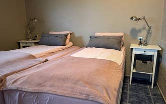 Twin beds pushed together in a bedroom of a holiday apartment in Hellissandur, West Iceland.
