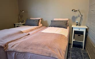 Twin beds pushed together in a bedroom of a holiday apartment in Hellissandur, West Iceland.