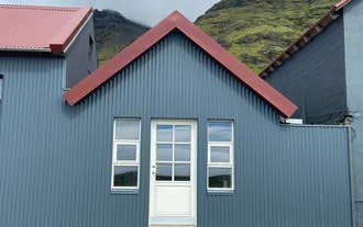 01-raudafell-apartment-exterior-red-roof-mountains.jpg