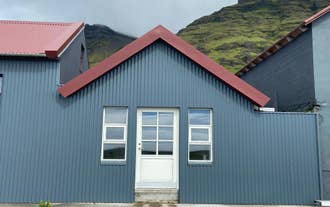 01-raudafell-apartment-exterior-red-roof-mountains.jpg
