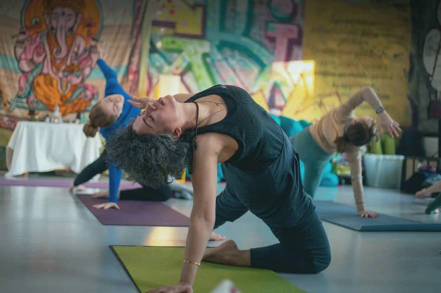 Participants stretching on mats during an indoor yoga class in Reykjavik.