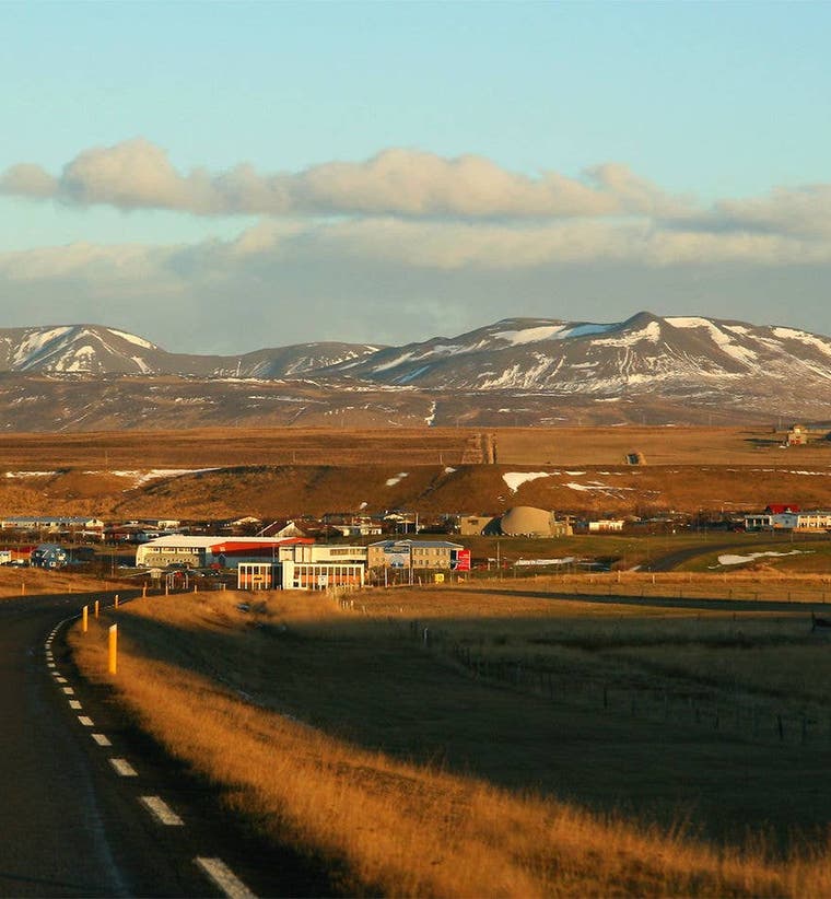 The town of Blonduos in North Iceland seen from the Ring Road with snow capped mountains behindApartments in Blonduos