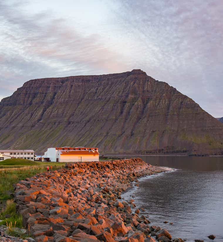 Aerial view of the village of Flateyri on its gravel spit in Onundarfjordur Fjord in the Westfjords.