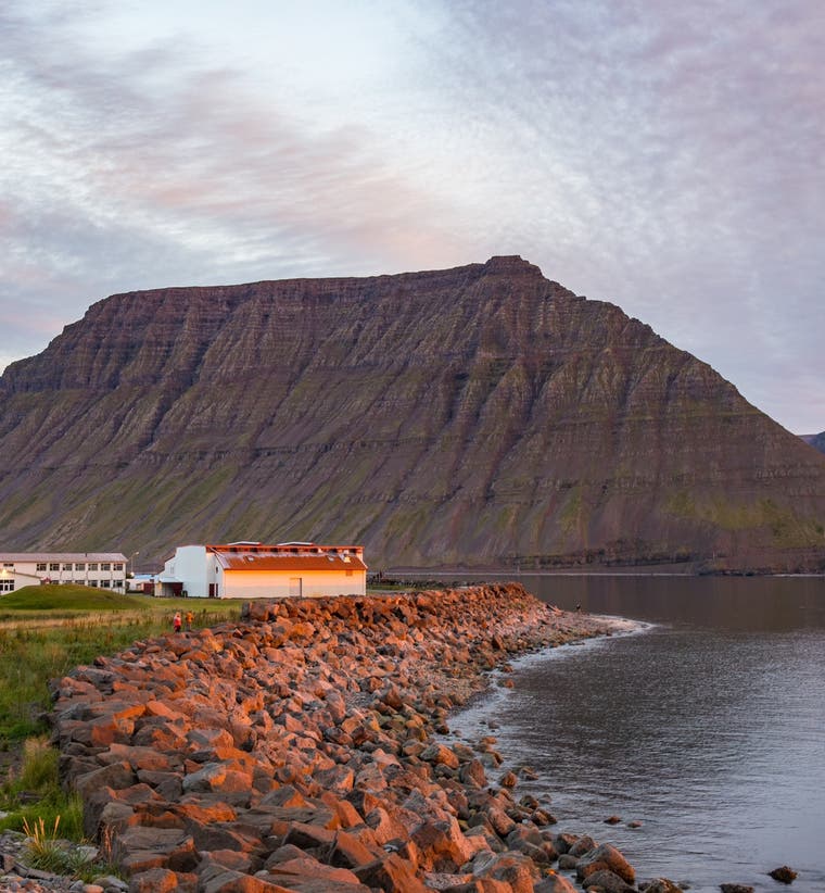 Aerial view of the village of Flateyri on its gravel spit in Onundarfjordur Fjord in the Westfjords.
