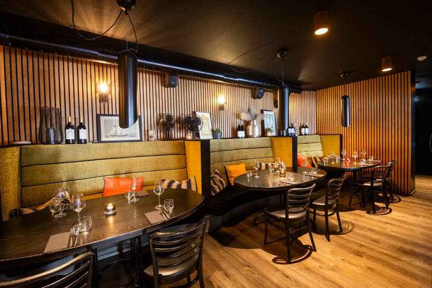The ground-floor dining room at Sjávargrillið in Reykjavik, lined with corrugated iron from an old Flatey ice house.