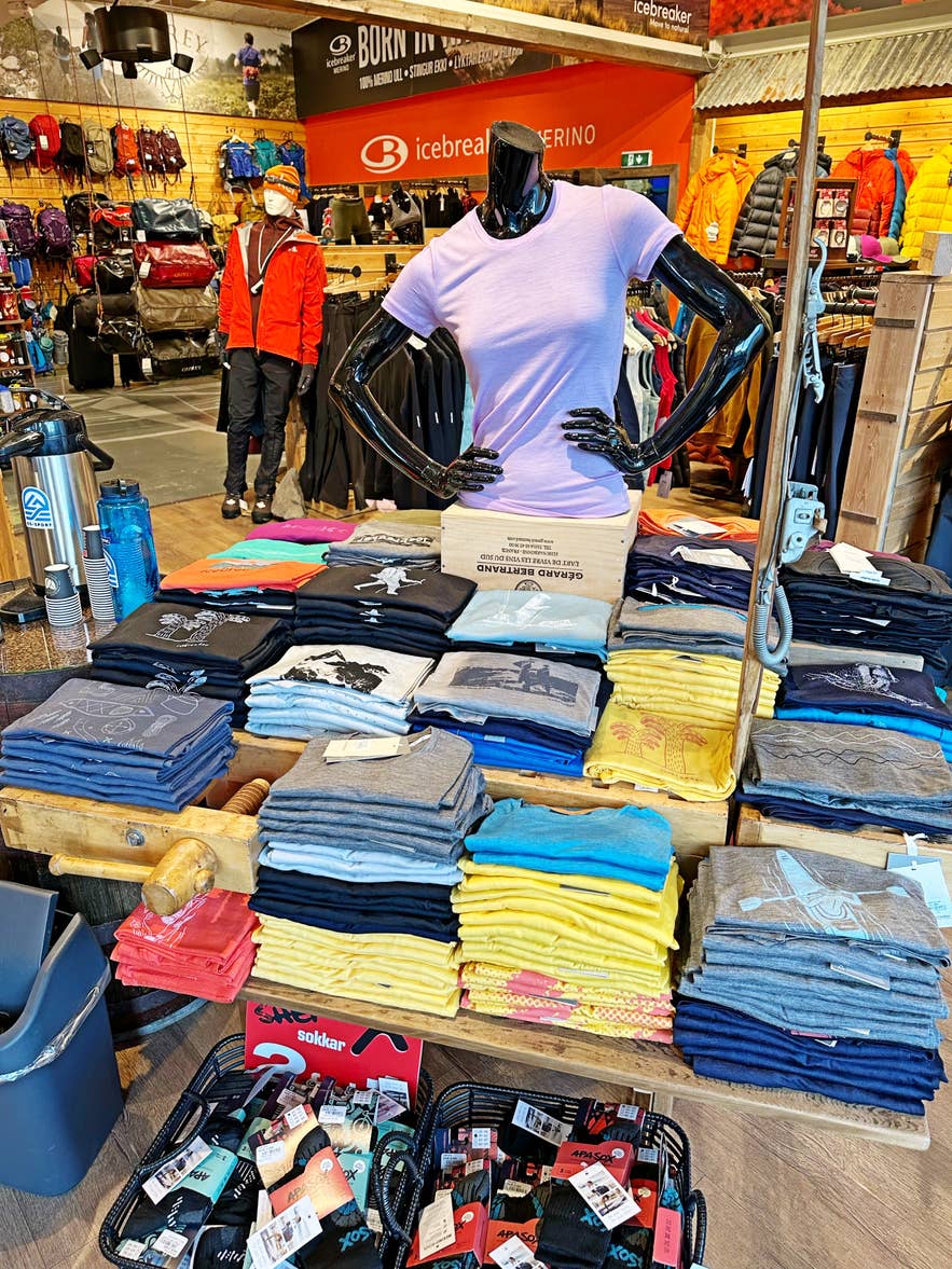 Outdoor clothing and folded T-shirts displayed inside the GG Sport store in Iceland.