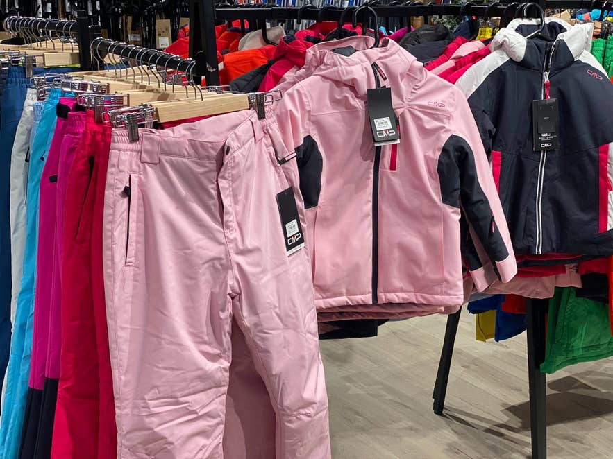 Outdoor jacket and pants displayed on racks inside GG Sport in Iceland.