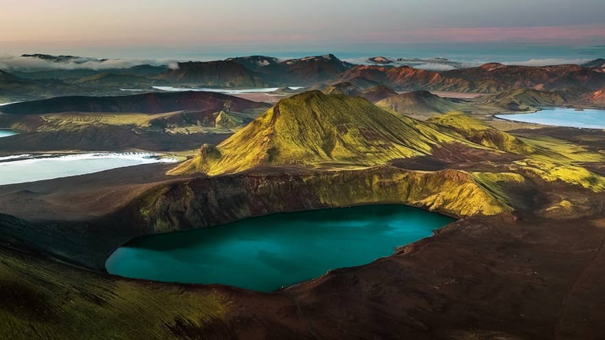 A summer landscape of green Icelandic countryside under long daylight hours.