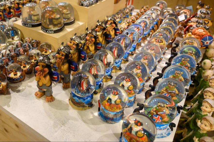 Rows of Iceland snow globes and troll figurines displayed on a gift shop table. Rows of Iceland snow globes and troll figurines displayed on a gift shop table.