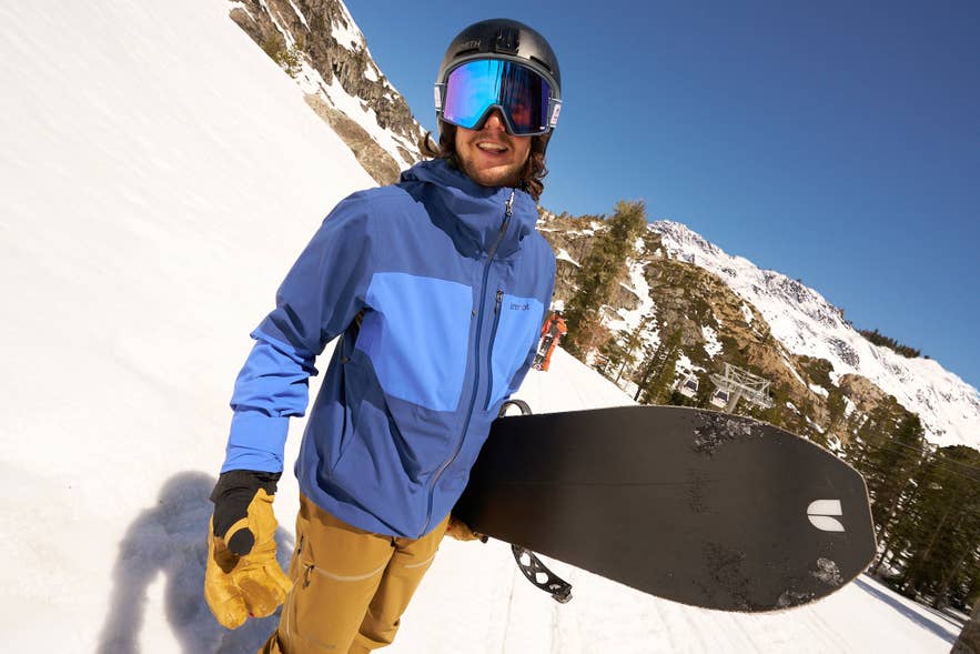 A snowboarder wearing a Smith helmet and goggles at an Icelandic ski resort.