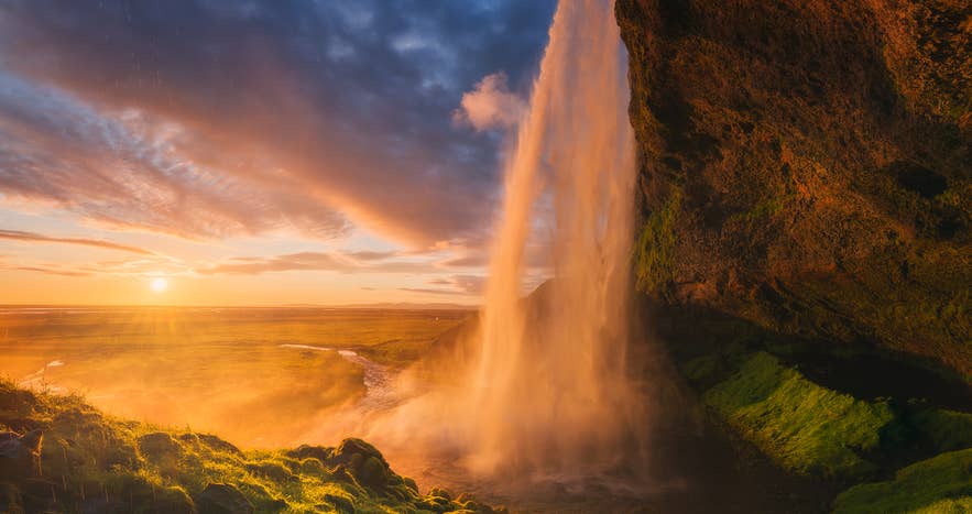 Seljalandsfoss Waterfall glowing gold at sunset, a scenic highlight of summer travel in Iceland. Seljalandsfoss Waterfall glowing gold at sunset, a scenic highlight of summer travel in Iceland.